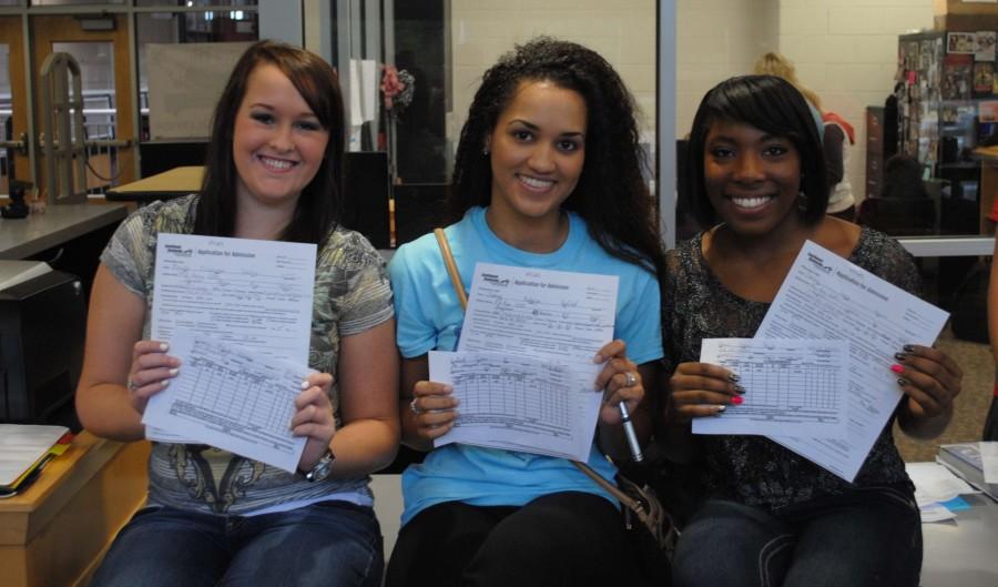 Kayla Curry, Sierra Hatfield and Deona Mimes were among the Harlan County students who registered for dual credit classes earlier this week at the HCHS library.