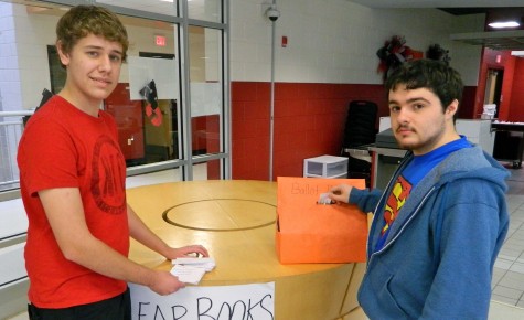 Andrew Hensley (left) was an election officer for the mock election at Harlan County High School and watched as Cameron Smith cast his vote.