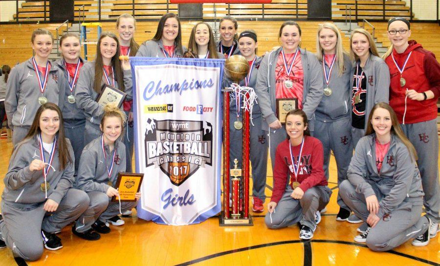 The Harlan County Lady Bears are pictured with their championship trophy and banner after winning the WYMT Mountain Classic title, the first in county history. Team members include, from left, front row: Morgan Blakley, Phebe McHargue, K.K. Johnson and Dixie Ewing; back row: Rebecca Middleton, Macie Napier, Hannay Gaw, Lainey Cox, Kaylea Gross, Shelby McDaniel, Blair Green, Breann Turner, Morgan Napier, Brooklyn Wood and Emily Long.