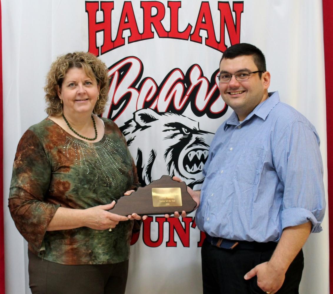 Harlan High School Principal Edna Burkhart presented an award to Spanish teacher Emmanuel Anama-Green for his recent selection as president-elect of the Kentucky World Language Association.