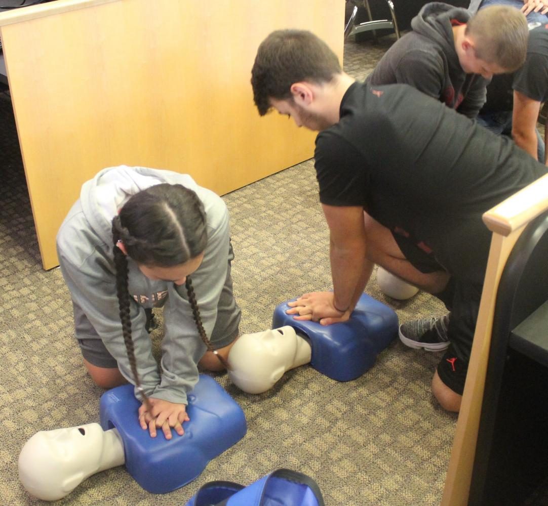 Sabrina Harris and Casey Lee practiced chest compressions in their CPR session at HCHS. 