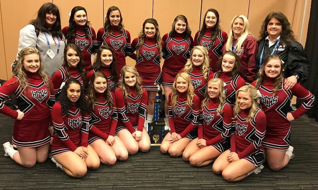Members of the Harlan County High School cheerleading squad posed with their state championship trophy Friday at Northern Kentucky University. Team members include, front left, front row: Keke Gist, Madison Tolliver, Mahalah Bundy, Rhileigh Alred, Baili Boggs and Ally Alred; middle row: Katiera Lewis, Amber Goodin, Bailey Brock, Peyton Griffin, Mahalah Bundy and Brittany Dummitt; back row: coach Anissa Alred, seniors Shawnee Cress, Karyssa Lamb, Kerstin Perkins, Grayson Raleigh and Emily Eldridge and coaches Whitney Alred and Holly Alred.